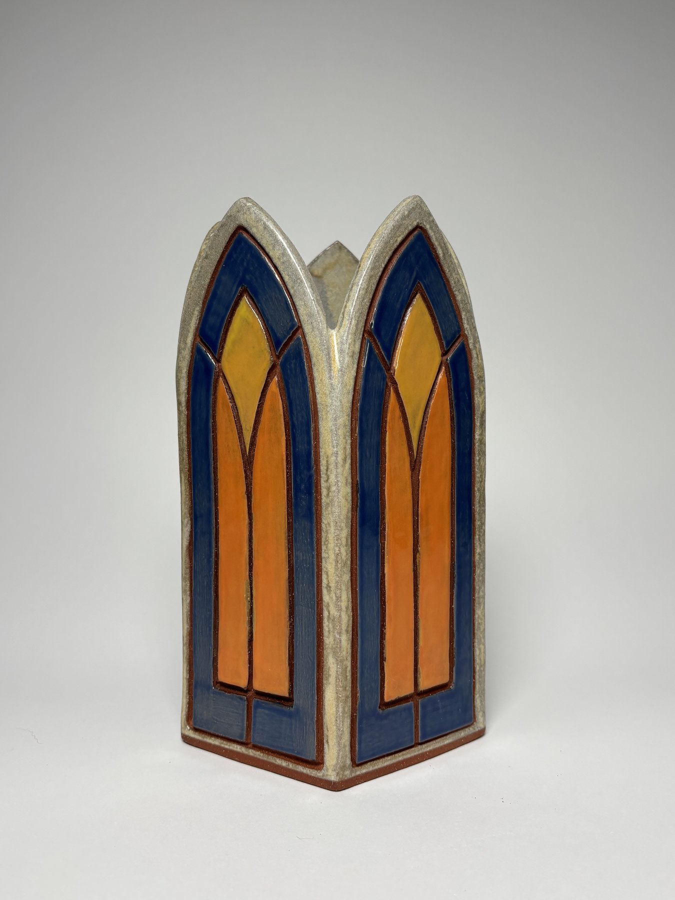 Tall gothic arch vase, blue and orange stained-glass glaze