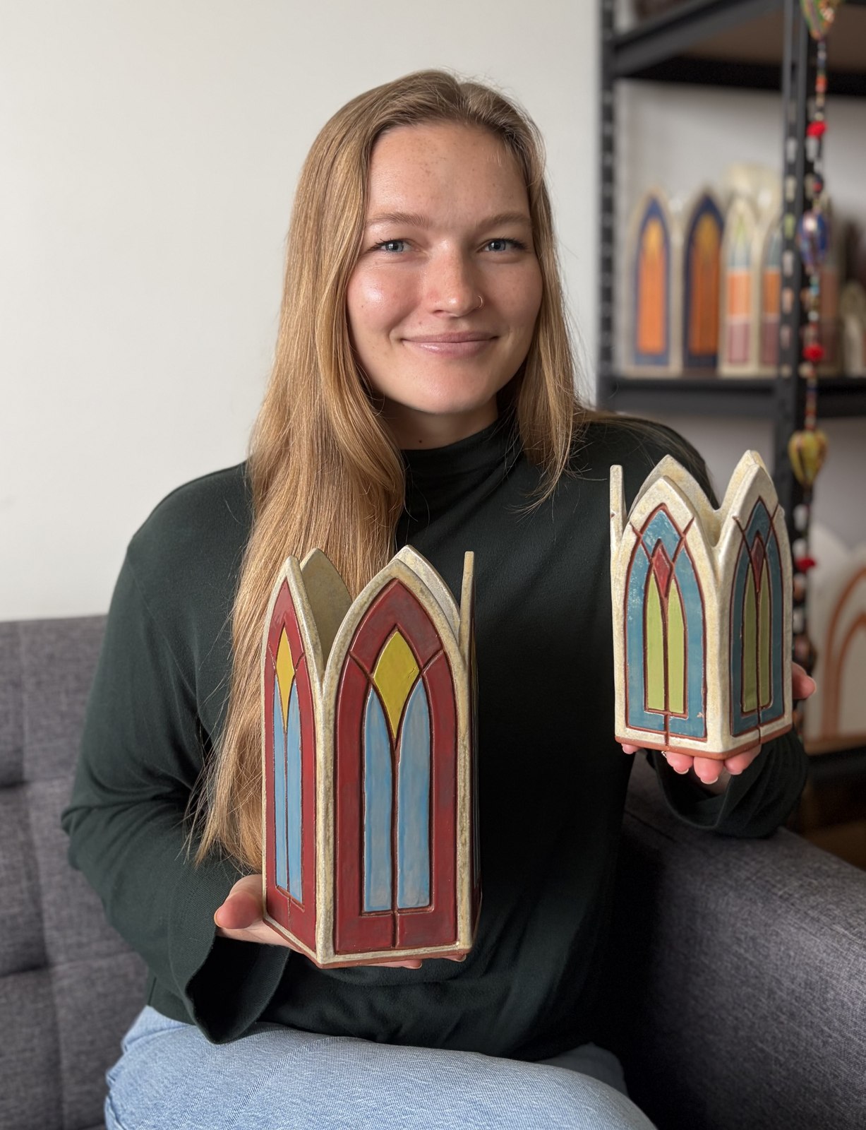 Lane Dye holding two of her Gothic arch vases